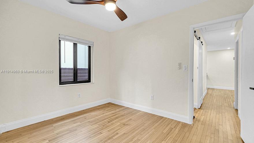 3764 Southwest 27th Lane, Unit 3762 Miami, FL 33134 - Photo 25 of 31 a view of an empty room with wooden floor