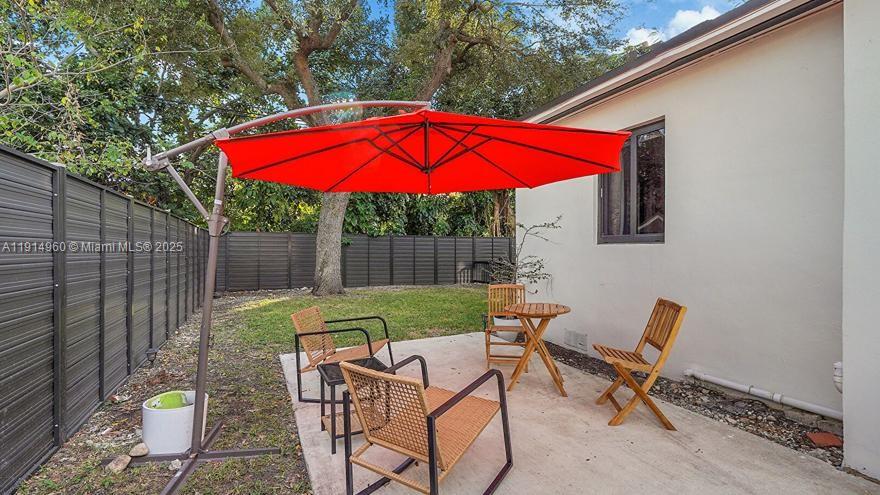 3764 Southwest 27th Lane, Unit 3762 Miami, FL 33134 - Photo 27 of 31 a view of backyard with swimming pool and outdoor seating