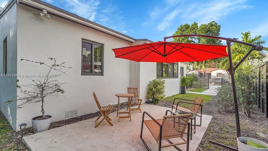 3764 Southwest 27th Lane, Unit 3762 Miami, FL 33134 - Photo 28 of 31 a view of an chairs and table in the patio