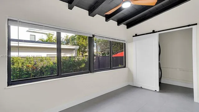 wooden floor in an empty room with large windows