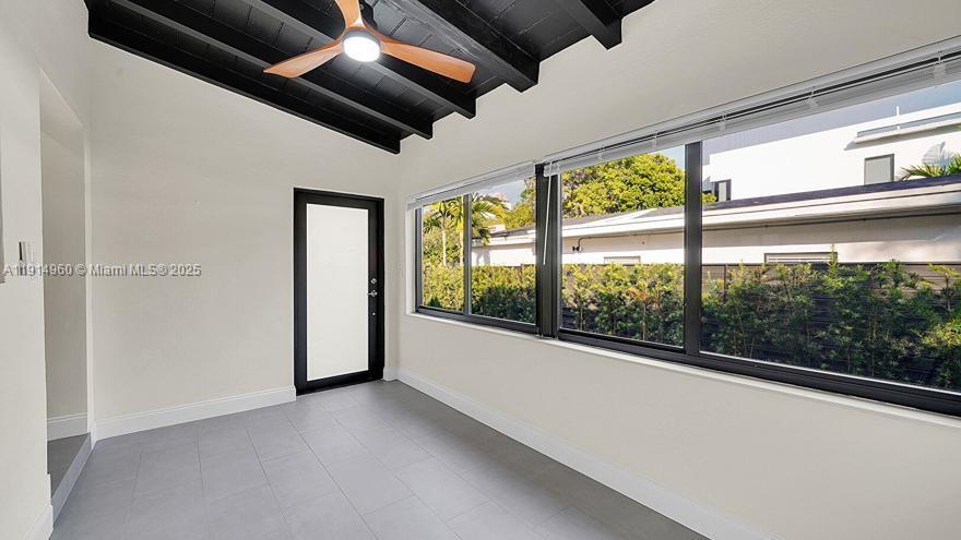 3764 Southwest 27th Lane, Unit 3762 Miami, FL 33134 - Photo 7 of 31 wooden floor in an empty room with large windows