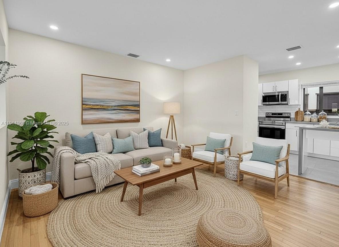 3764 Southwest 27th Lane, Unit 3762 Miami, FL 33134 - Photo 9 of 31 a living room with furniture a rug and a potted plant