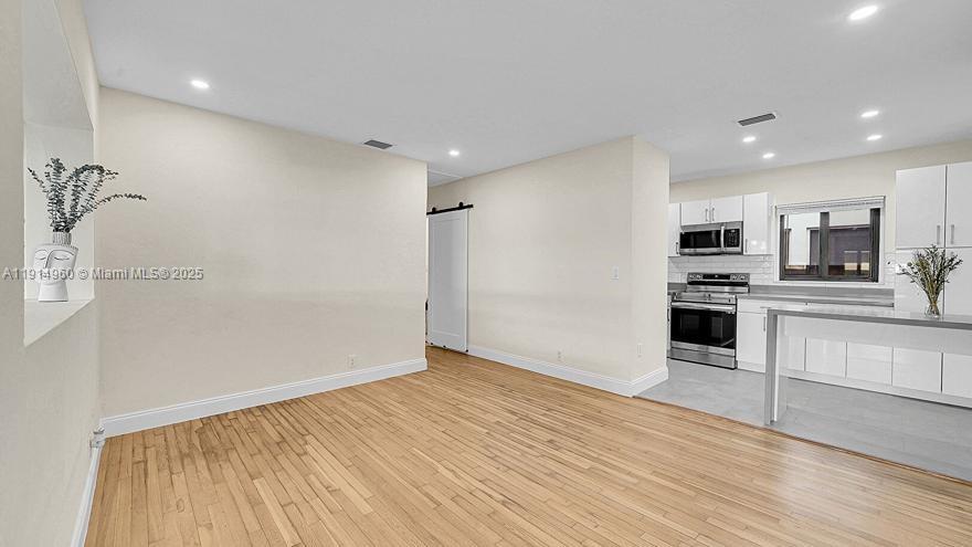 3764 Southwest 27th Lane, Unit 3762 Miami, FL 33134 - Photo 10 of 31 a view of kitchen with wooden floor and electronic appliances