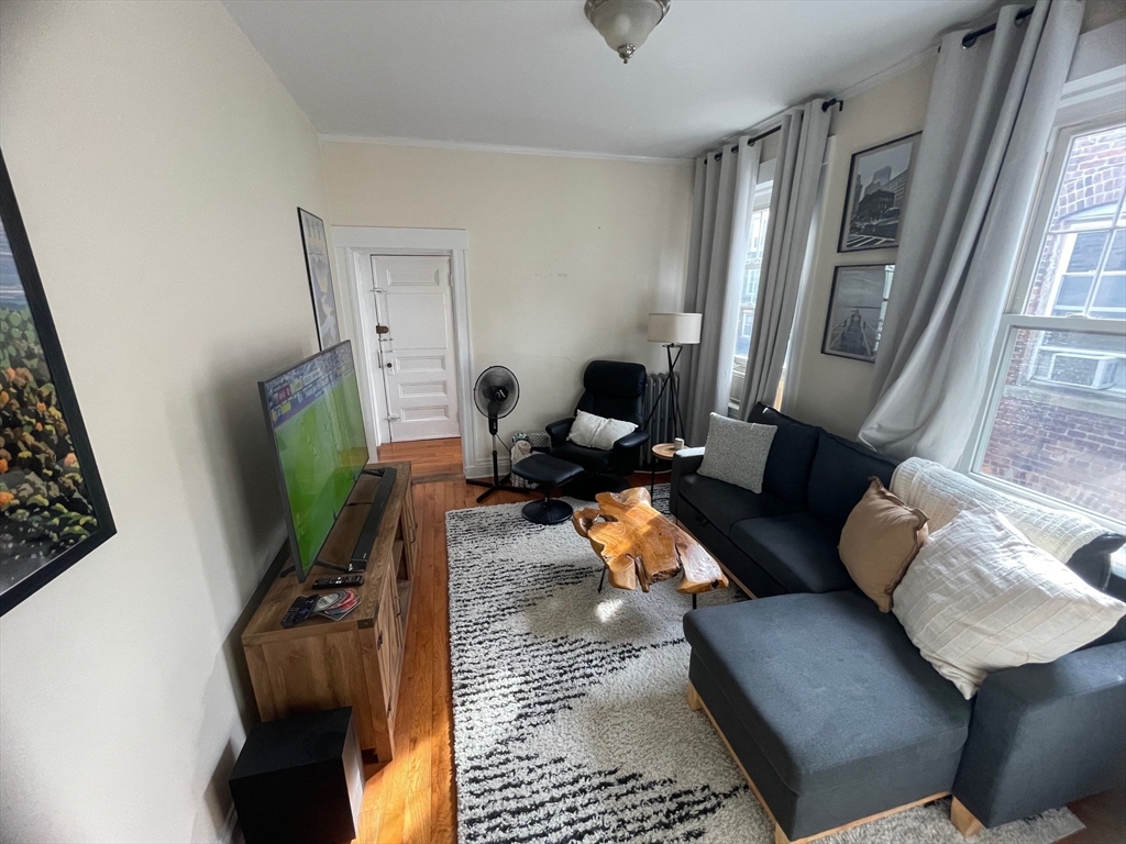30 Reedsdale Street, Unit 6 Boston, MA 02134 - Photo 5 of 11 a living room with furniture and a flat screen tv