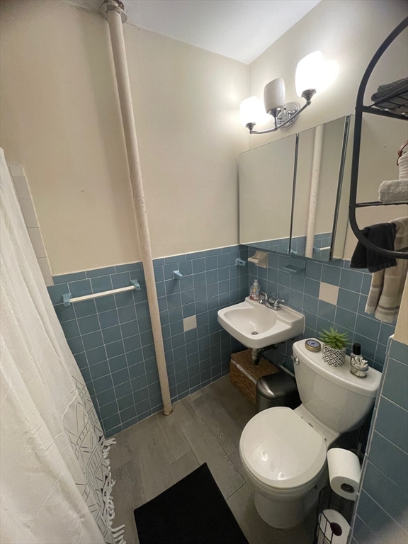 30 Reedsdale Street, Unit 6 Boston, MA 02134 - Photo 8 of 11 a bathroom with a sink toilet and mirror