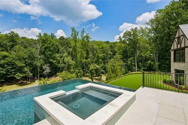 a living room with furniture a fireplace and a chandelier