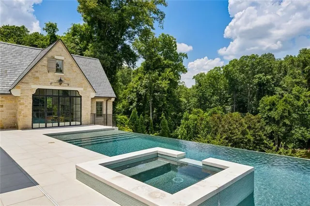 a bedroom with a large bed and a flat screen tv