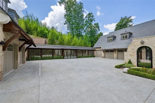 a spacious bathroom with a double vanity sink a mirror and a bathtub