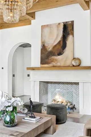 a living room with fireplace furniture and a large window