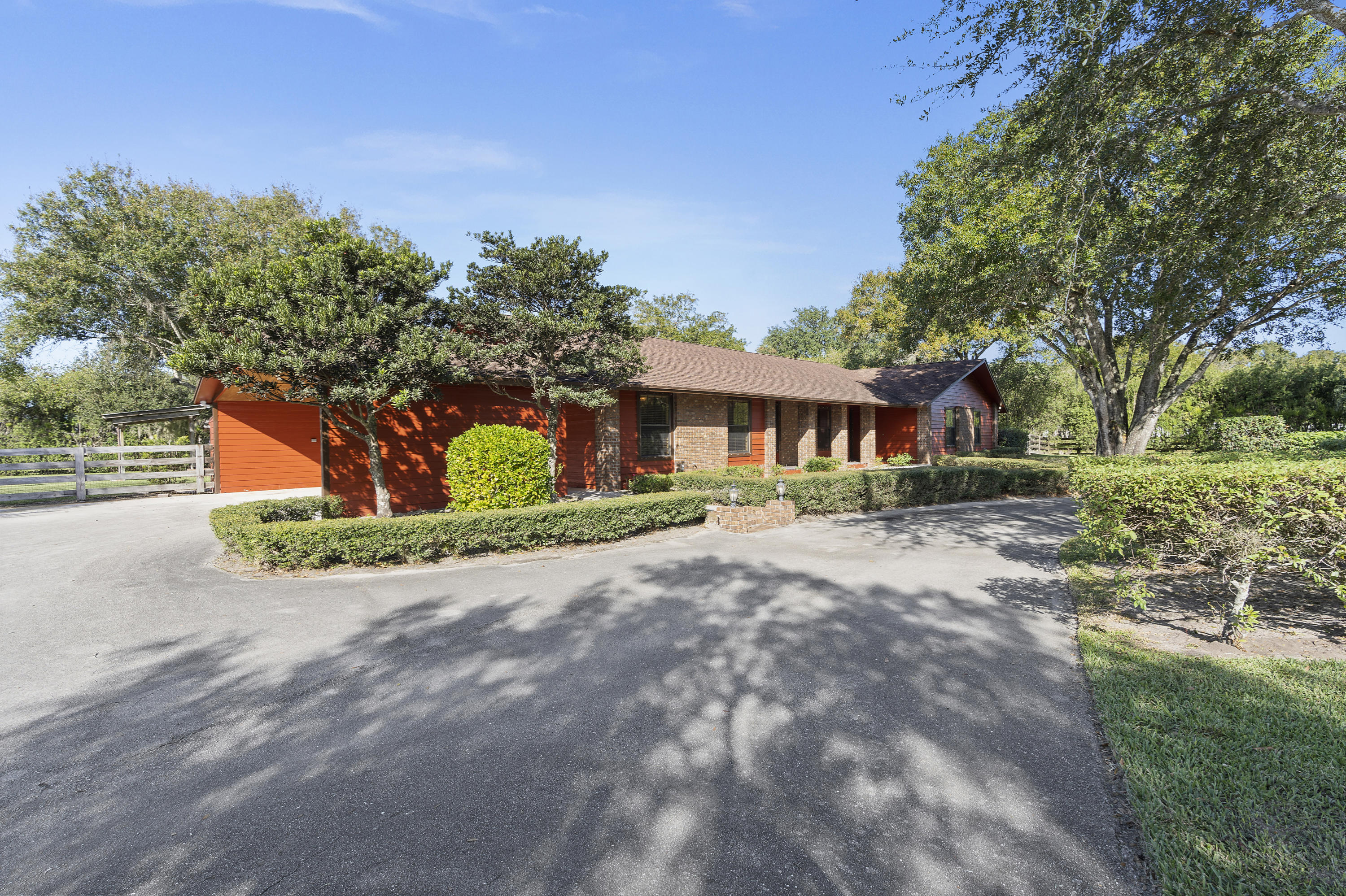4851 Jorgensen Road Fort Pierce, FL 34981 - Photo 23 of 36 a front view of a house with a yard and garage