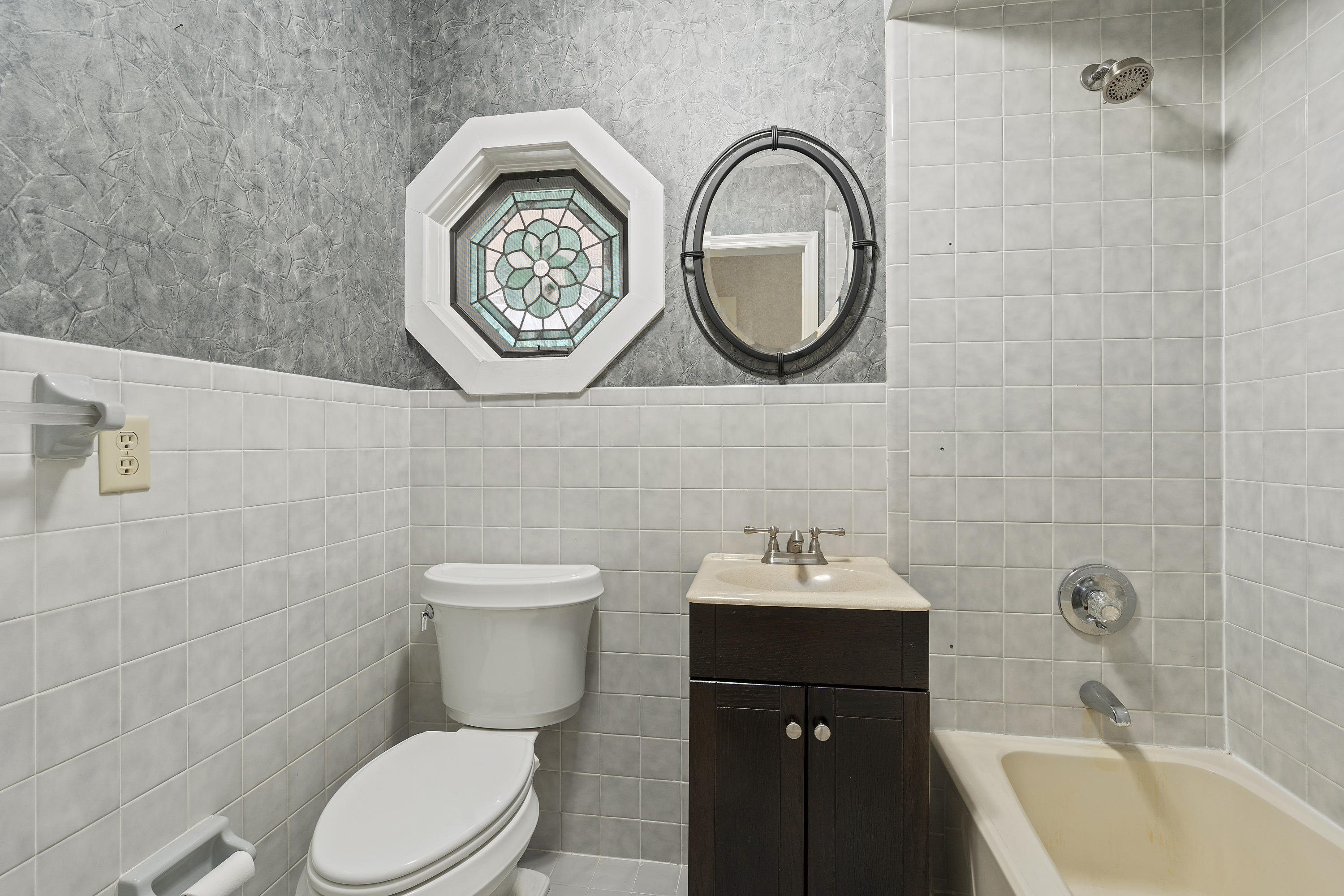 4851 Jorgensen Road Fort Pierce, FL 34981 - Photo 8 of 36 a bathroom with a toilet sink and mirror