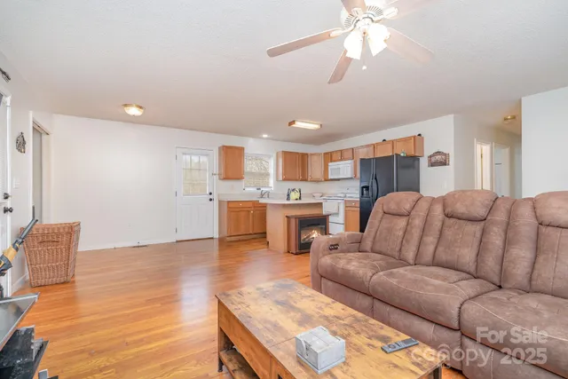 a living room with furniture and kitchen view