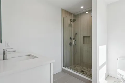a bathroom with a toilet and a shower