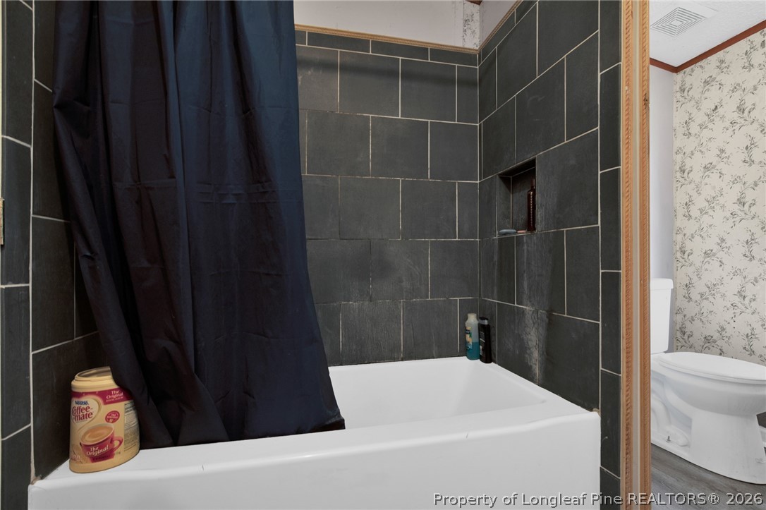 4705 Hickory Ridge Road Parkton, NC 28371 - Photo 32 of 37 a bathroom with a bathtub and shower