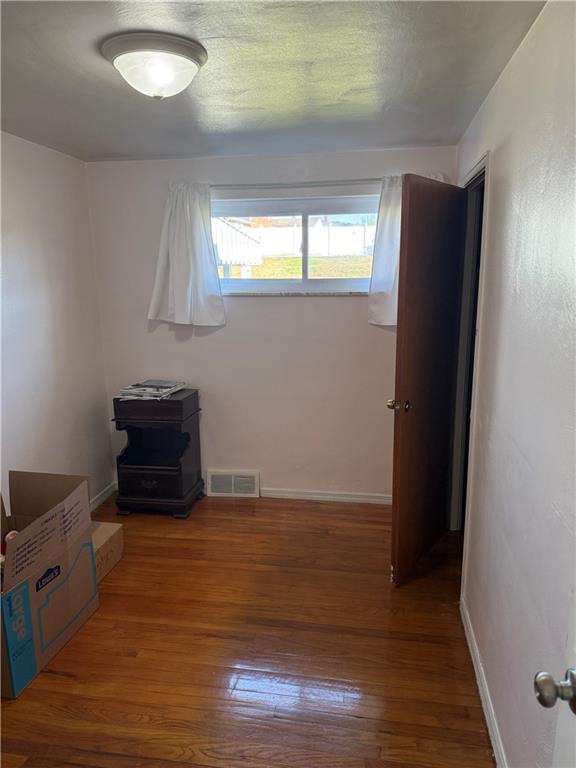 662 Lindsay Road Carnegie, PA 15106 - Photo 13 of 19 a view of an empty room with wooden floor and a window