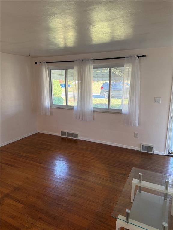 662 Lindsay Road Carnegie, PA 15106 - Photo 5 of 19 an empty room with wooden floor and windows