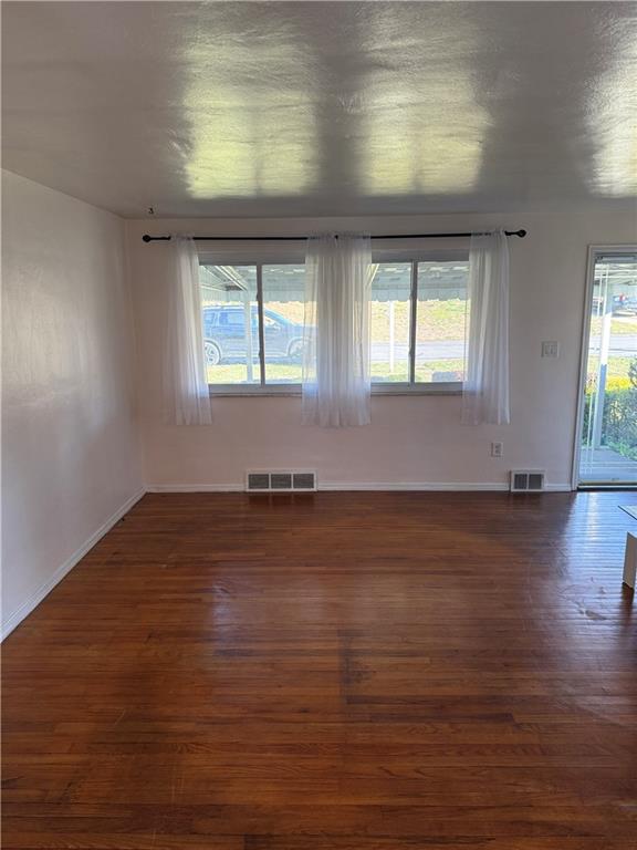 662 Lindsay Road Carnegie, PA 15106 - Photo 6 of 19 an empty room with wooden floor and windows