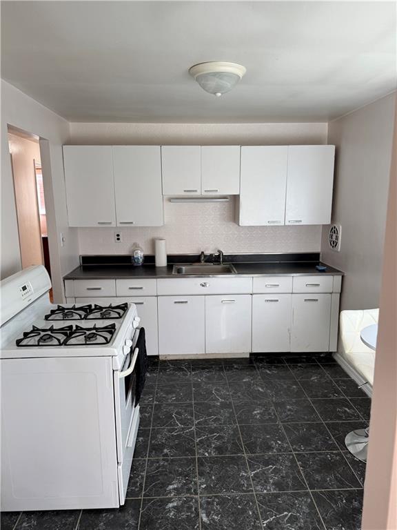662 Lindsay Road Carnegie, PA 15106 - Photo 9 of 19 a kitchen with granite countertop a stove sink and cabinets