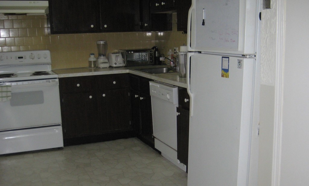 294 Codman Hill Road, Unit 108 Boxborough, MA 01719 - Photo 5 of 5 a kitchen with a refrigerator and cabinets