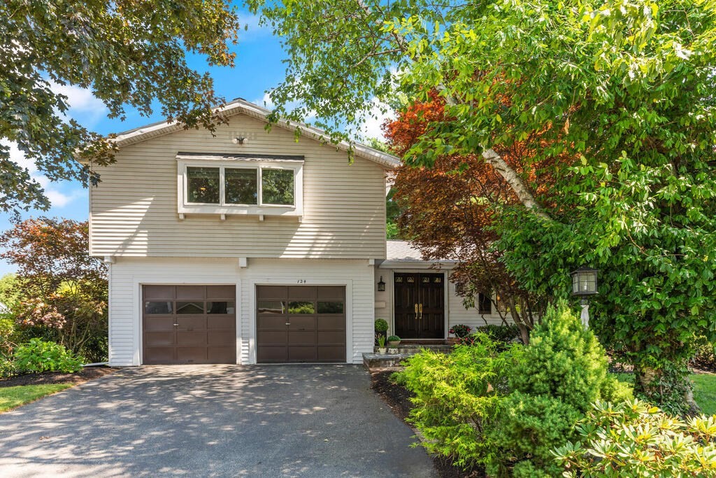 a front view of a house with a garden