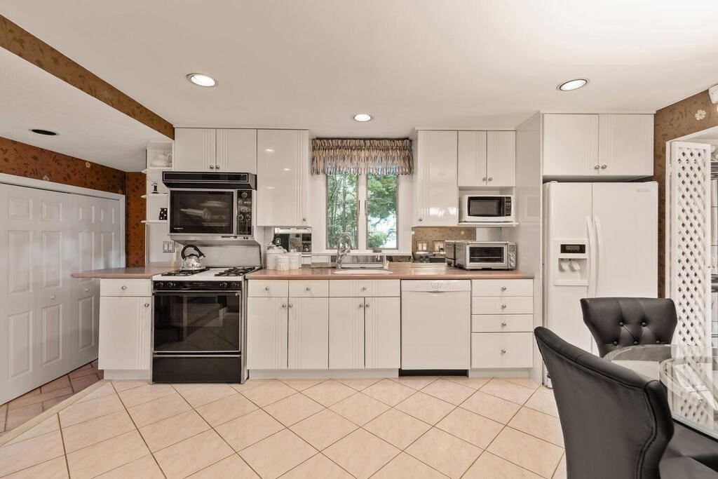 124 Damon Road Needham, MA 02494 - Photo 14 of 42 a kitchen with cabinets stainless steel appliances and window