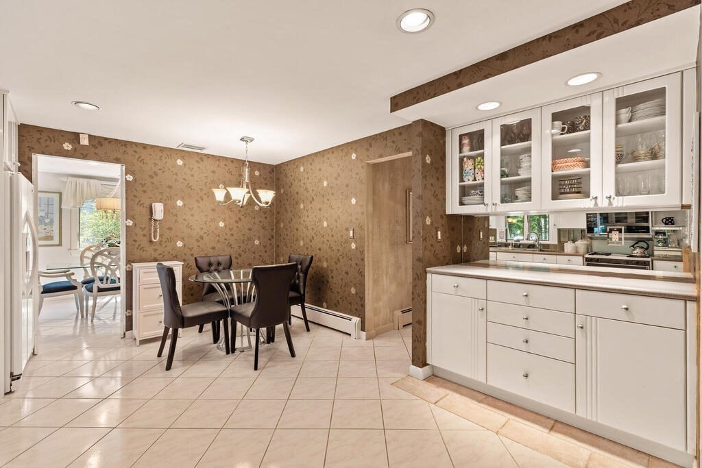 124 Damon Road Needham, MA 02494 - Photo 15 of 42 a kitchen with stainless steel appliances kitchen island granite countertop a table and chairs in it