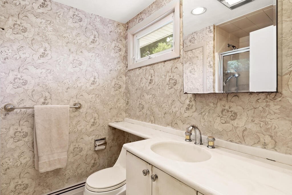 124 Damon Road Needham, MA 02494 - Photo 24 of 42 a bathroom with a sink mirror vanity and toilet