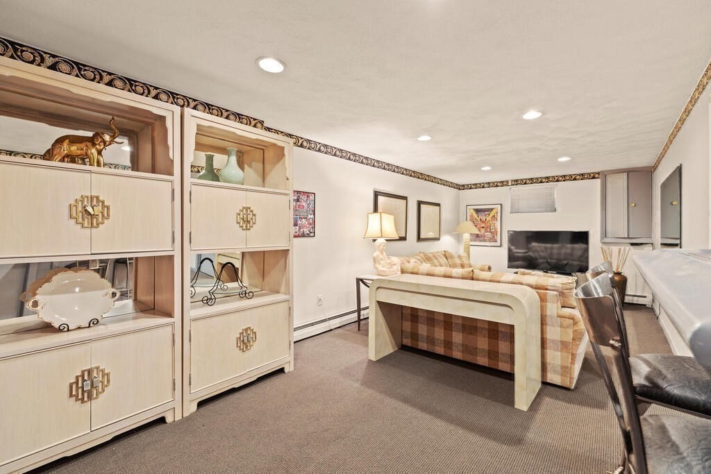 124 Damon Road Needham, MA 02494 - Photo 34 of 42 a view of living room kitchen with furniture and flat screen tv