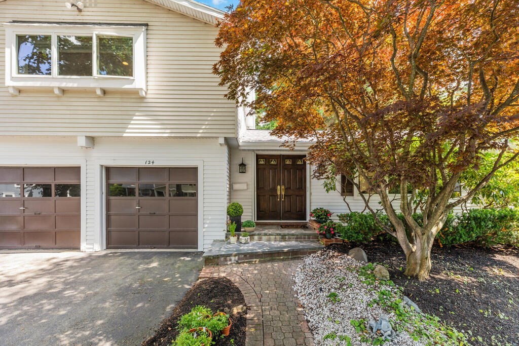 124 Damon Road Needham, MA 02494 - Photo 4 of 42 a front view of a house with a yard and garage