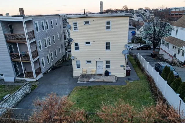 a view of a house with backyard and sitting area