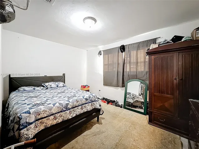 a bedroom with a bed and cabinets