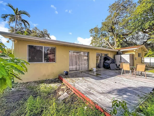 a front view of house with yard outdoor seating and barbeque oven
