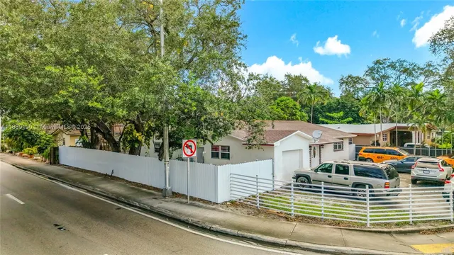 a front view of a house with a garden and outdoor seating