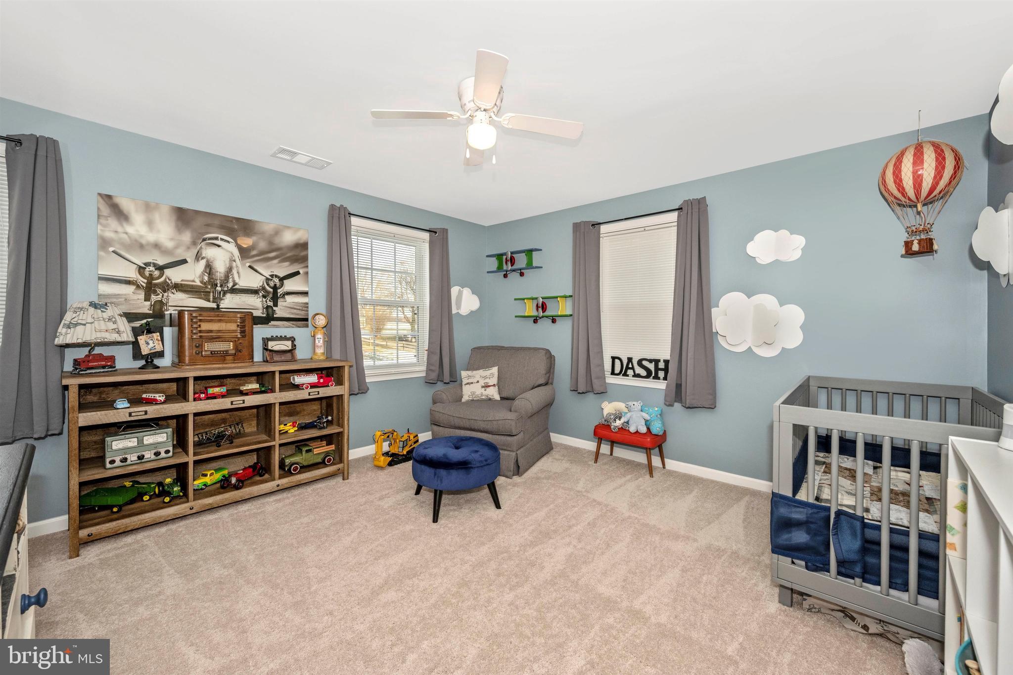 12529 Fingerboard Road Monrovia, MD 21770 - Photo 32 of 55 a living room with furniture a baby crib and a book shelf