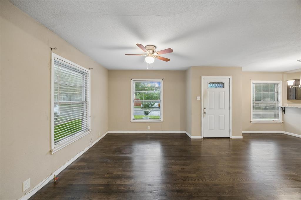 117 Moon Street Cleburne, TX 76033 - Photo 7 of 28 a view of an empty room with wooden floor and a window
