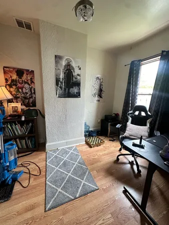 a bedroom with furniture and a window