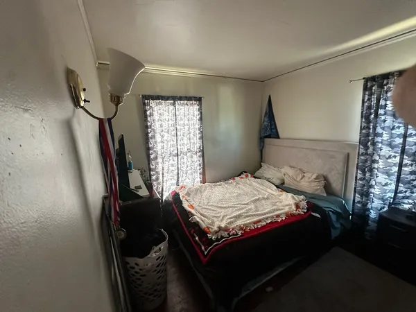 a bedroom with a bed and a window
