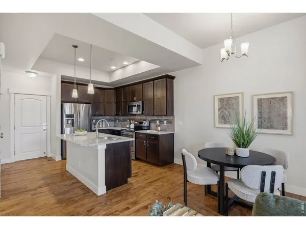 a kitchen with kitchen island a stove a table and chairs