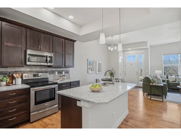 a kitchen with a sink stove and microwave