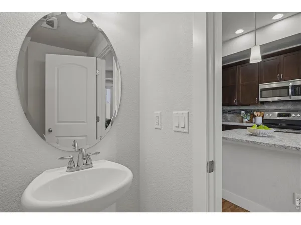 a bathroom with a sink a mirror and cabinets