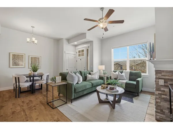 a living room with furniture a lamp a rug and a window