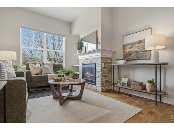 a living room with furniture a fireplace and a table