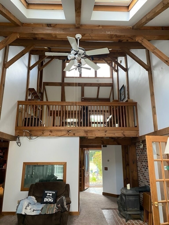 209 Gaffney Road Oakham, MA 01068 - Photo 11 of 42 a living room with fireplace furniture and a window