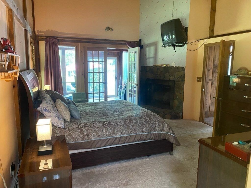 209 Gaffney Road Oakham, MA 01068 - Photo 13 of 42 a spacious bedroom with a bed and a television