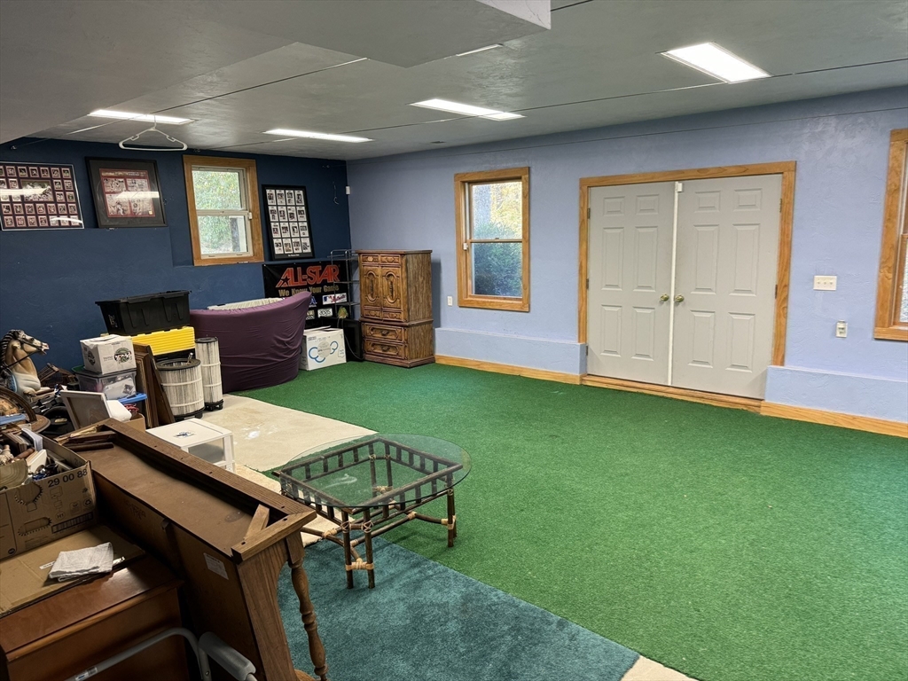 209 Gaffney Road Oakham, MA 01068 - Photo 23 of 42 a living room with a table chairs and a fireplace