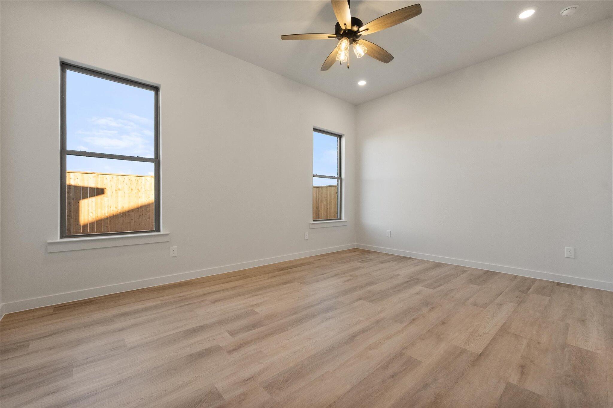 5309 Remington Avenue Lubbock, TX 79407 - Photo 11 of 22 an empty room with a window and a fan