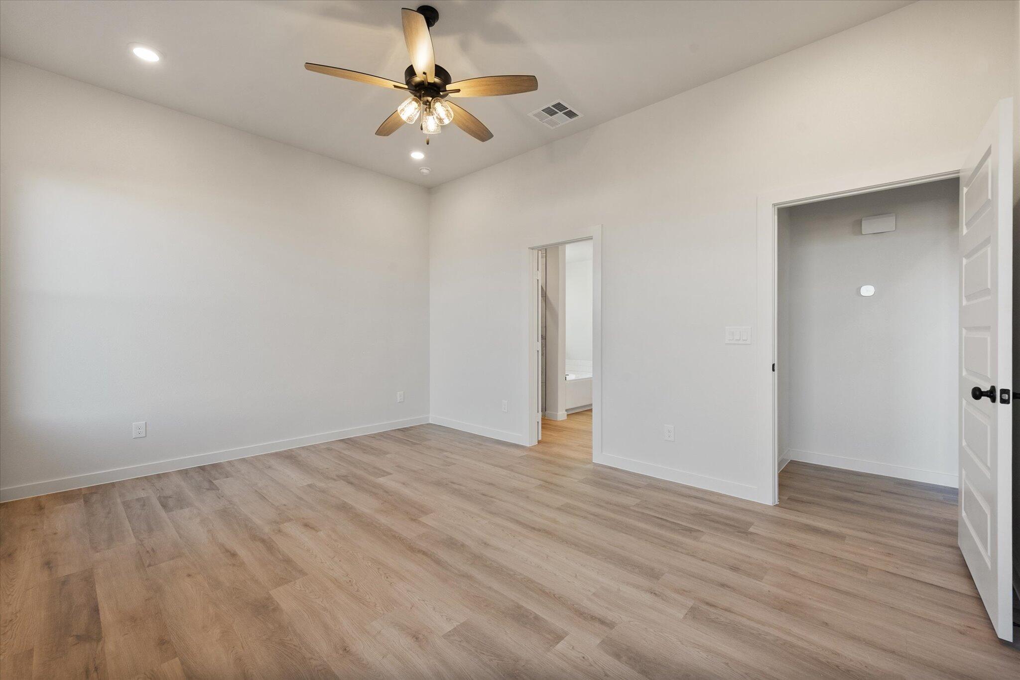 5309 Remington Avenue Lubbock, TX 79407 - Photo 12 of 22 a view of an empty room with wooden floor