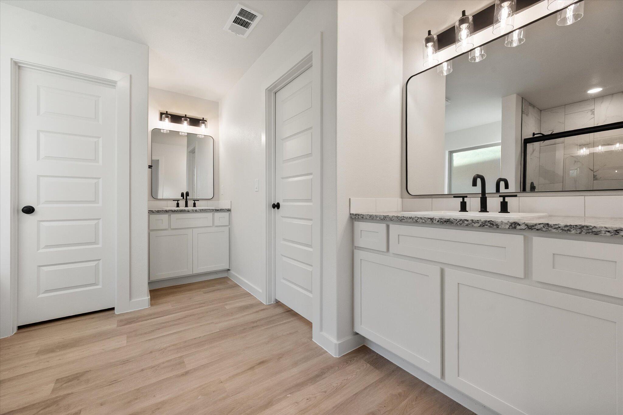 5309 Remington Avenue Lubbock, TX 79407 - Photo 13 of 22 a bathroom with a sink and a mirror