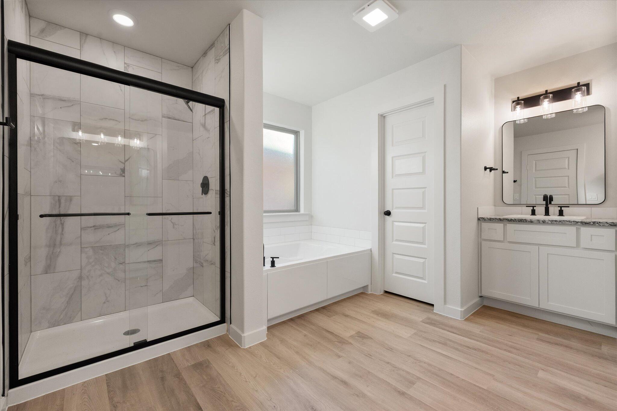 5309 Remington Avenue Lubbock, TX 79407 - Photo 14 of 22 a bathroom with a glass shower door and a sink