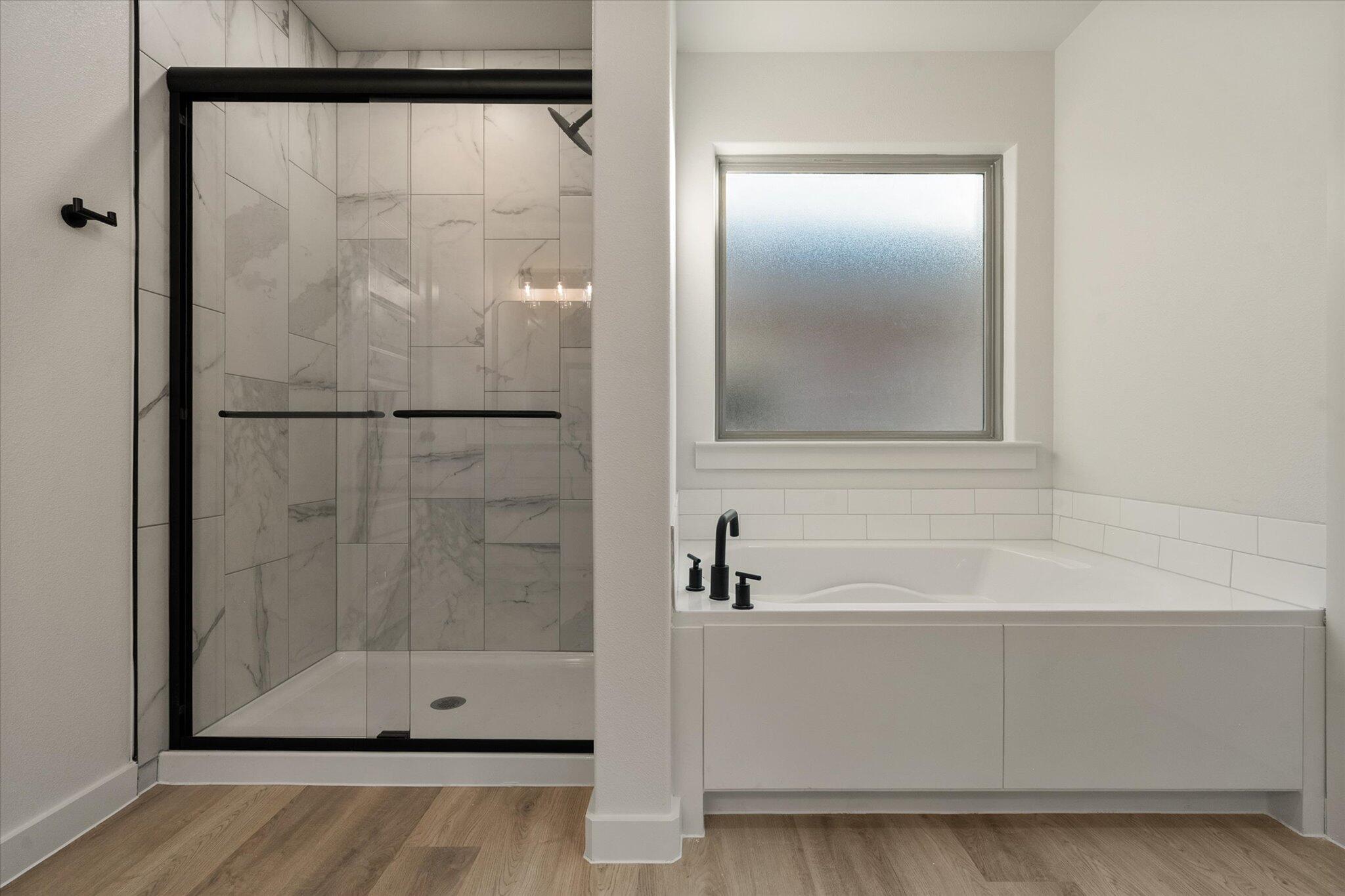 5309 Remington Avenue Lubbock, TX 79407 - Photo 15 of 22 a bathroom with a glass shower door